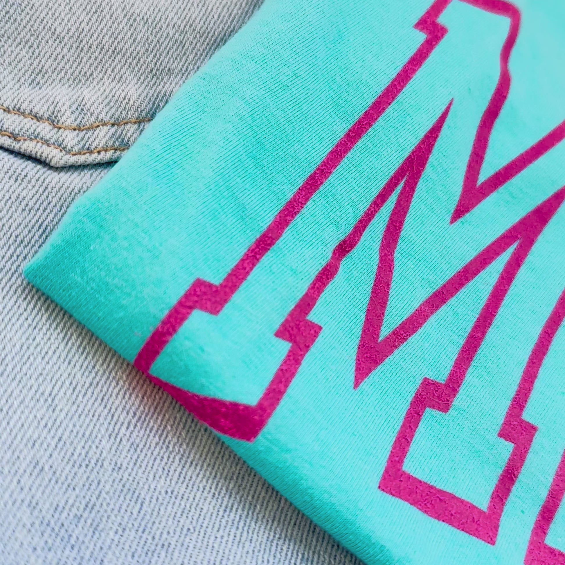 MAMA teal shirt with bold pink lettering up close video